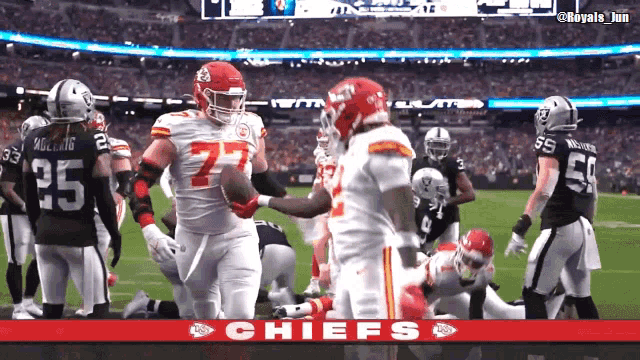 a football game between the chiefs and the raiders is being played