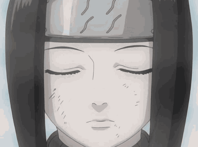 a close up of a person 's face with their eyes closed and a headband on