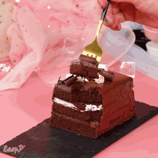 a piece of chocolate cake is being eaten with a fork and the word easyp is on the bottom right
