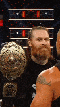 a man with a beard is wearing a belt that says duke
