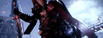 a man in a red armor is holding a sword in a dark room .