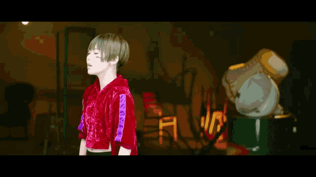 a girl with short hair is wearing a red crop top
