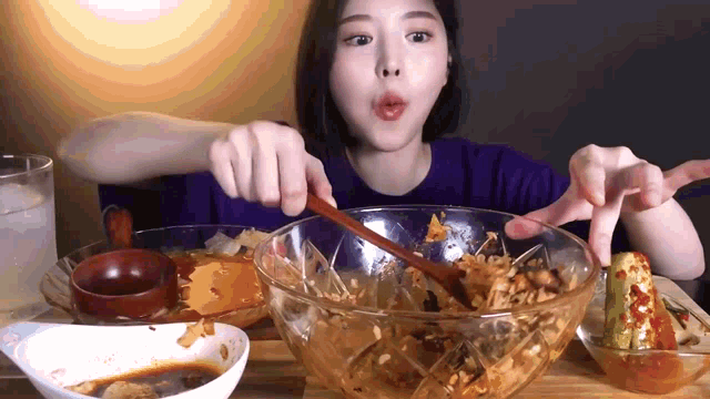 a woman is eating a bowl of food with a spoon