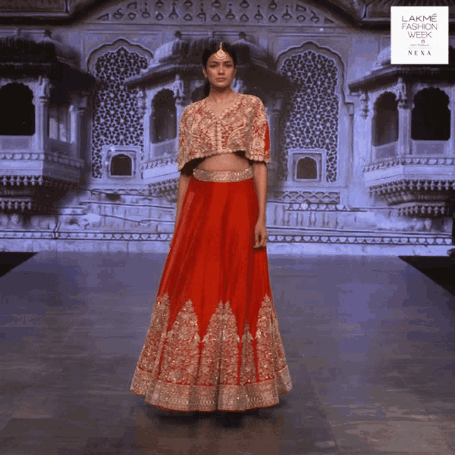 a model walks down a runway at lakme fashion week