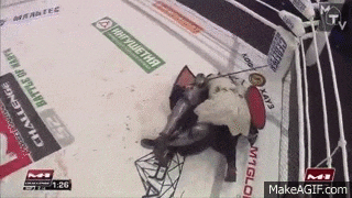 a man is wrestling another man in a ring .