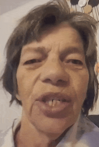 a close up of a woman 's face with a few teeth missing