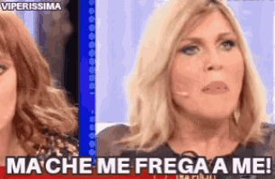 a woman says mache me frega a me while sitting next to another woman .