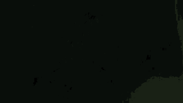 a silhouette of a demon with horns in a green light