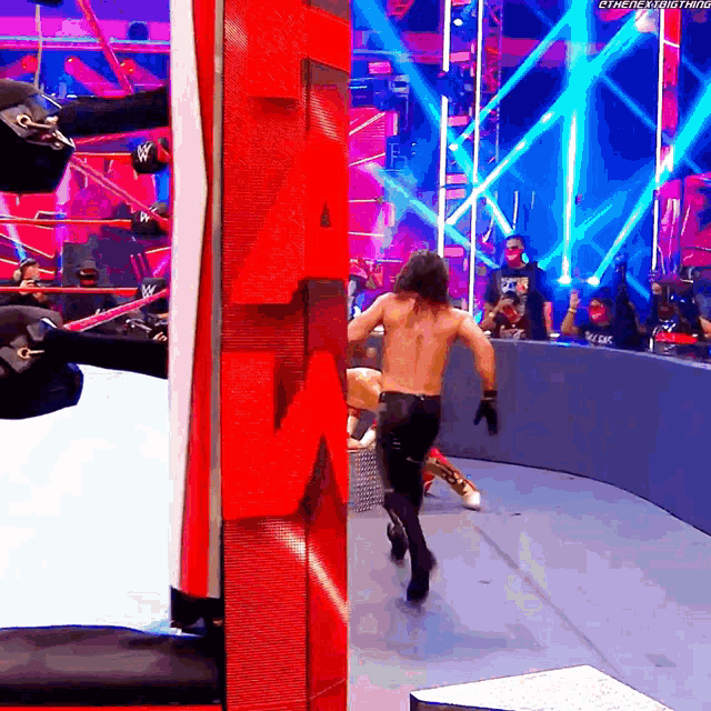 a man in a wrestling ring with a red letter a on the wall behind him