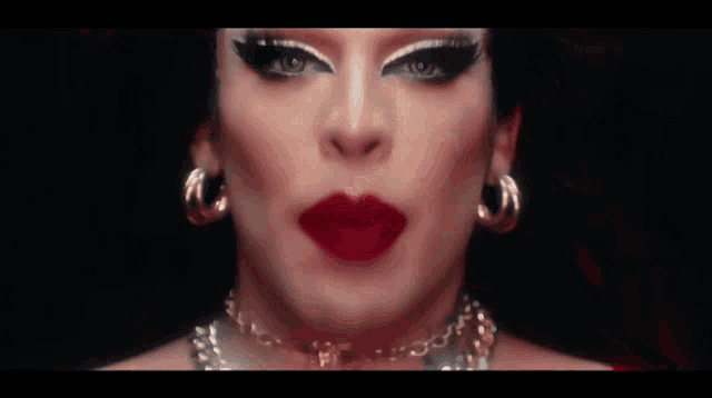 a close up of a woman 's face with red lips