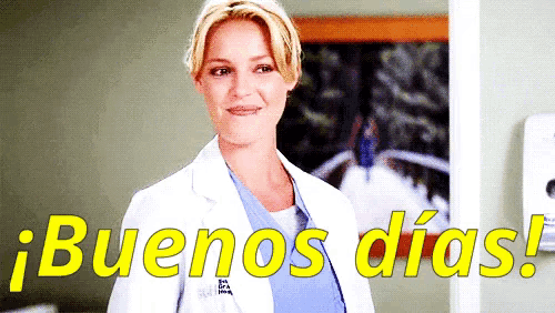 a woman in a lab coat is standing in front of a sign that says " buenos dias "