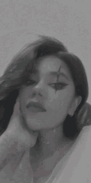 a close up of a woman 's face with a star painted on her eye .
