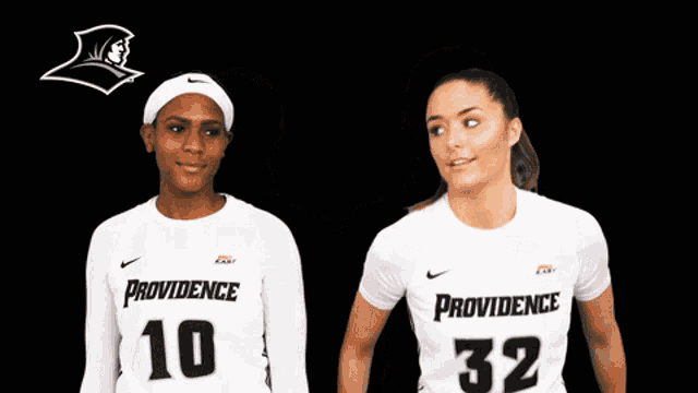 two women wearing providence jerseys number 10 and 32 are standing next to each other