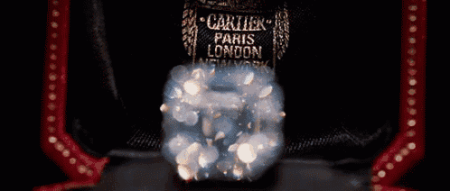 a large square diamond is sitting on top of a black surface .