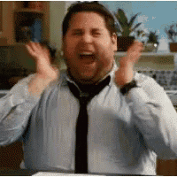 a man in a blue shirt and tie is making a funny face .