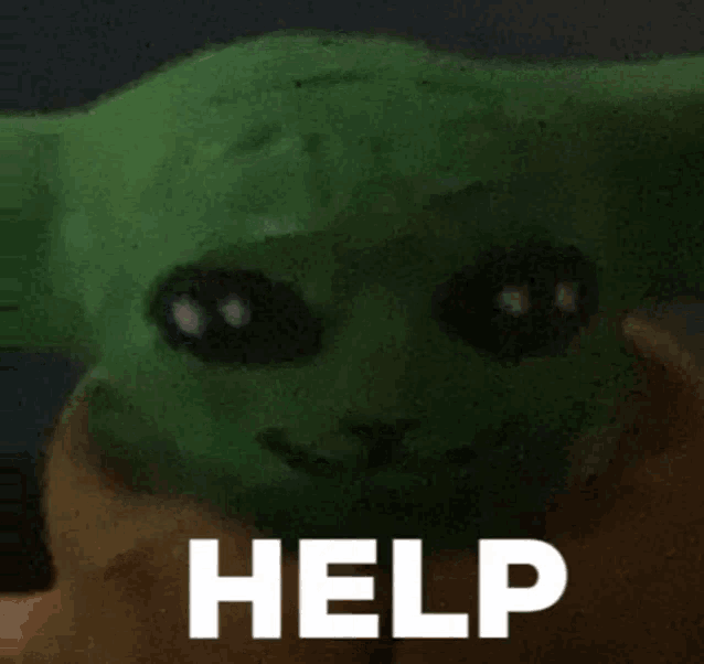 a close up of a green baby yoda with the word help written on it