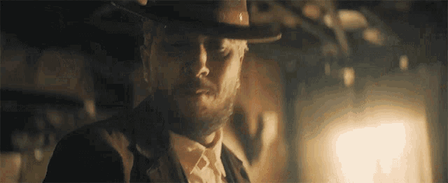 a man with a beard is wearing a hat and bow tie