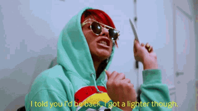 a woman wearing sunglasses and a hoodie says i told you i 'd be back