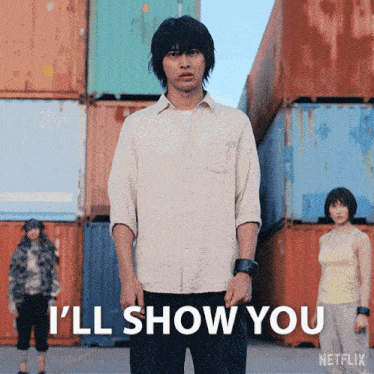 a man stands in front of a stack of shipping containers with the words i 'll show you below him