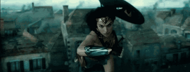 wonder woman is flying through the air with a shield