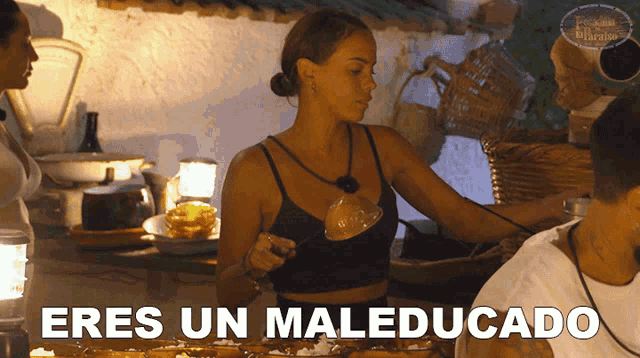 a woman in a black top is holding a ladle and the words eres un maleducado are above her