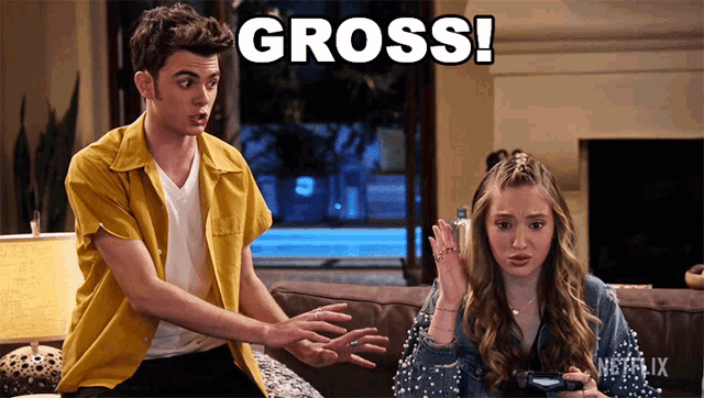 a boy and a girl are sitting on a couch and the girl is holding a video game controller and the boy is saying gross