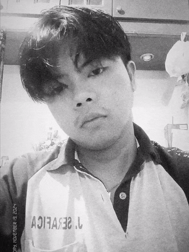 a black and white photo of a man taken on november 19th 2021