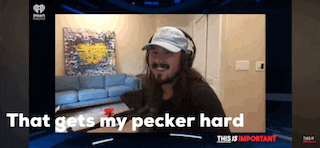 a man wearing headphones and a hat says that gets my pecker hard on a screen
