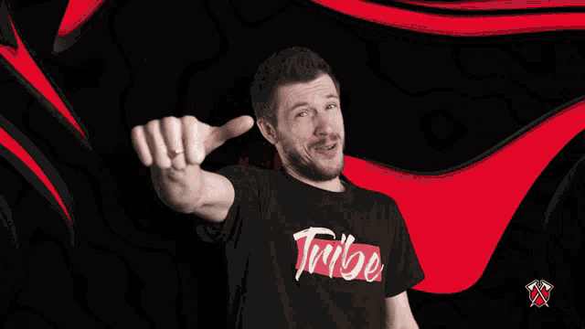 a man giving a thumbs up wearing a shirt that says tribe