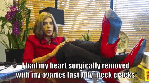 a woman wearing red high heels has her feet up on a table