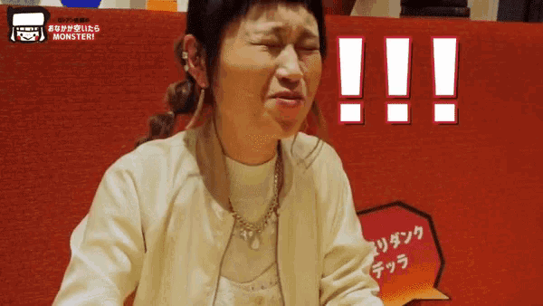 a woman is crying in front of a monster sign