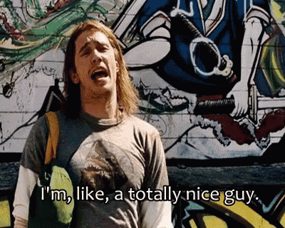 a man in front of a graffiti wall says i 'm like a totally nice guy ..
