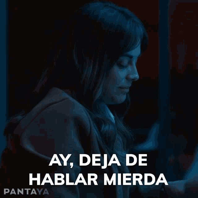 a woman is looking at her phone with the words ay deja de hablar mierda behind her