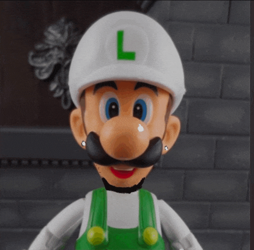 a mario figure with a white hat and a green letter l on his hat