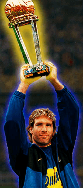 a man holding up a trophy that says ' uefa ' on it