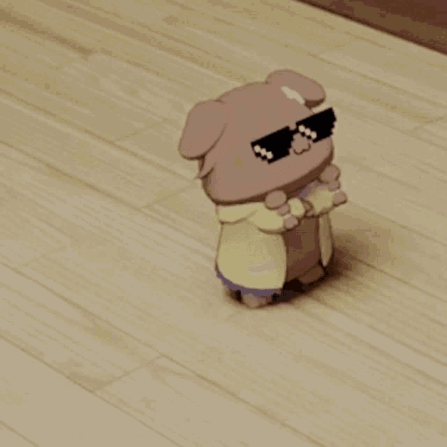 a stuffed animal wearing sunglasses is laying on the floor