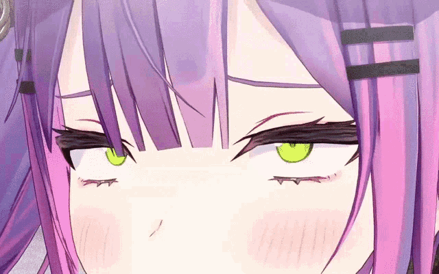 a close up of a girl 's eyes with purple hair