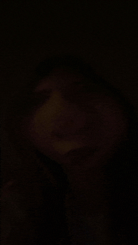 a close up of a person 's face in the dark