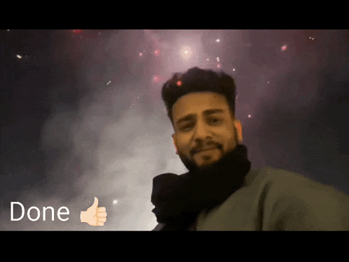 a man giving a thumbs up in front of a fireworks display with the word done below him