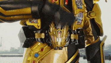 a close up of a gold and black robot with a dragon head