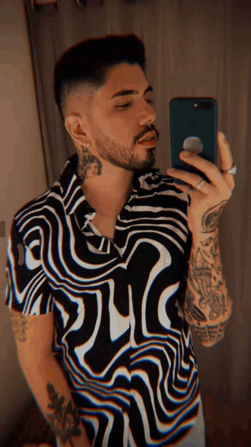 a man taking a picture of himself with his cell phone