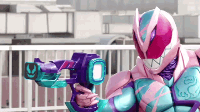 a person in a pink and blue costume is holding a purple gun .