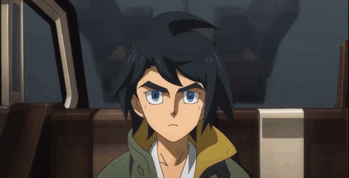 a boy with blue eyes and black hair is sitting in a chair