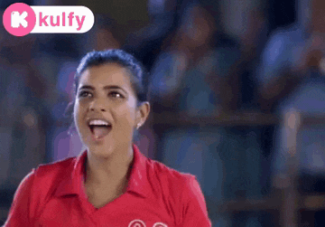 a woman wearing a red shirt with the number 03 on it is smiling