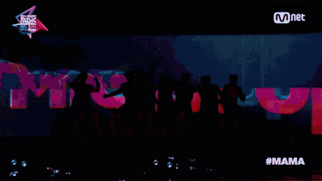 a silhouette of a group of people on a stage with the hashtag #mama on the bottom