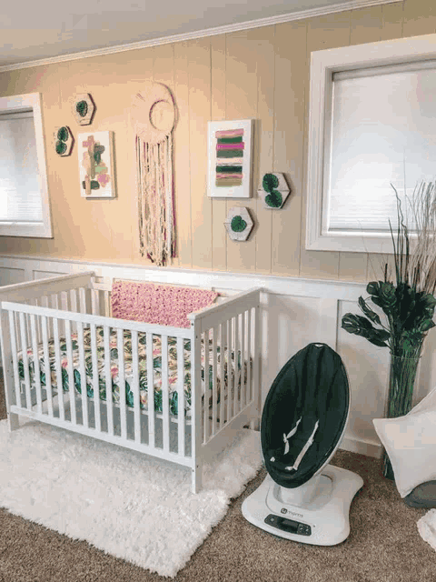 a baby room with a crib and a swing