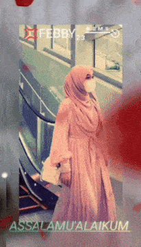 a picture of a woman wearing a hijab and a face mask with the date febby 23