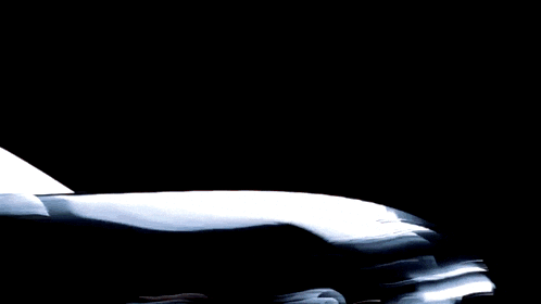 a silver sports car with a black wheel