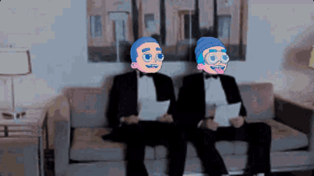 two men in tuxedos are sitting on a couch holding papers