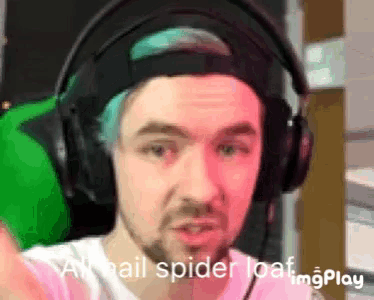 a man with blue hair is wearing headphones and says a hail spider loaf
